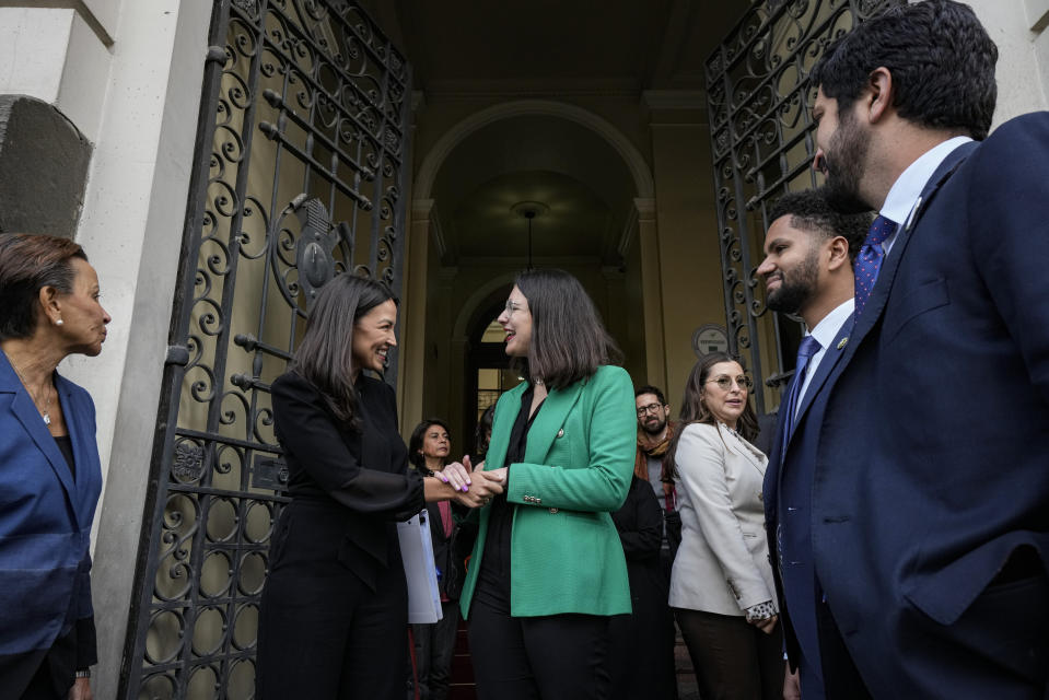 Congresswoman Alexandria Ocasio-Cortez, (D-NY), center left, shakes hands with Mayor Iraci Hassler, in Santiago, Chile, Thursday, Aug. 17, 2023. Ocasio-Cortez is part of a US delegation who traveled to the South American country to learn about efforts to defend its democracy ahead of the 50th anniversary of the military coup led by Gen. Augusto Pinochet. (AP Photo/Esteban Felix)