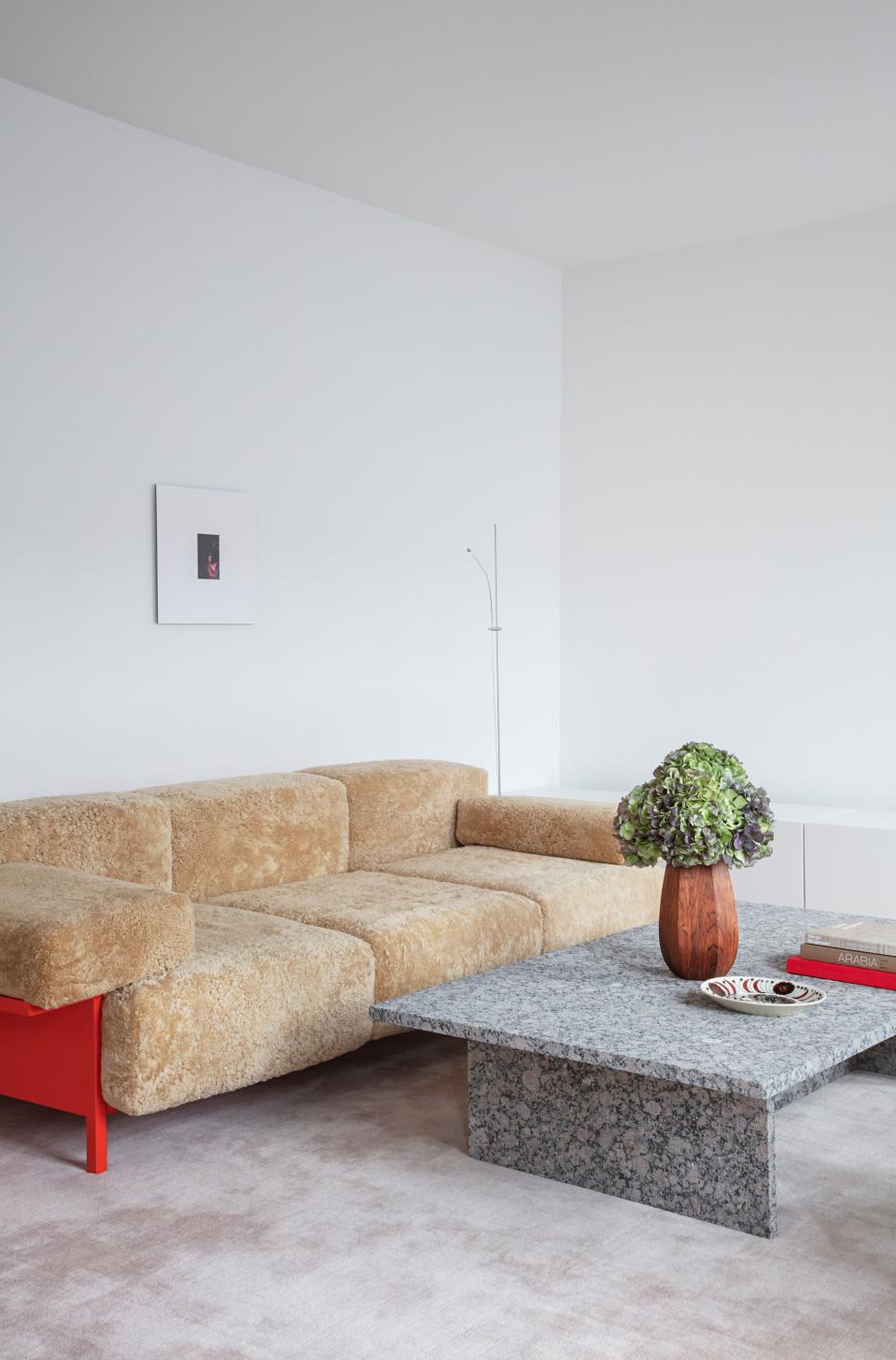 In the living room, the sheepskin-covered sofa is Thulstrup’s Mooner design for Common Seating, the granite cocktail table was custom made, and the rug is by Massimo.