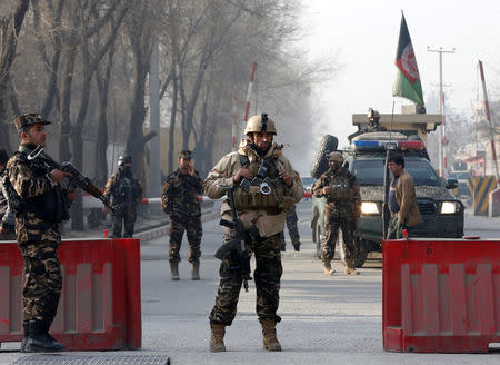 Afghan security forces keep watch at a check point close to the compound of Afghanistan's national intelligence agency in Kabul, Afghanistan. December 25, 2017. REUTERS/Omar Sobhani