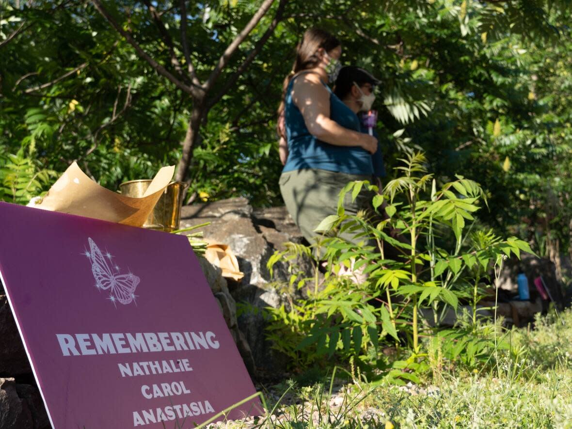 A placard at a women's monument in Petawawa, Ont., remembers Nathalie Warmerdam, Carol Culleton and Anastasia Kuzyk, who were all murdered by a man in and around Renfrew County in 2015. (Jean Delisle/CBC - image credit)