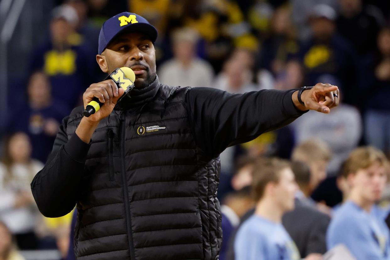 Michigan Wolverines head football coach Sherrone Moore addresses the basketball crowd during a timeout against the Iowa Hawkeyes at Crisler Center in Ann Arbor on Saturday, Jan. 27, 2024.