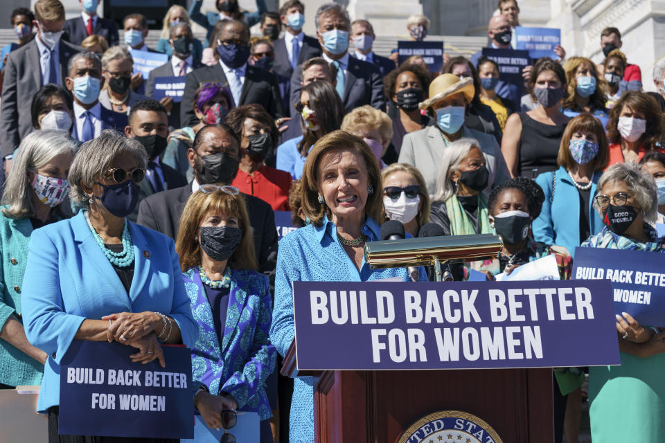 In this Sept. 24, 2021 photo, House Speaker Nancy Pelosi, D-Calif., holds a rally in support of President Joe Biden's "Build Back Better" for women agenda, at the Capitol in Washington. President Joe Biden’s plan for a massive expansion of social programs is being framed by supporters as such a high-stakes endeavor that it’s “too big to fail.” It also may be too big to describe. That’s a particular challenge as the White House struggles to sell the public on a wide range of initiatives packaged under the imprecise slogan of “Build Back Better.” (AP Photo/J. Scott Applewhite)