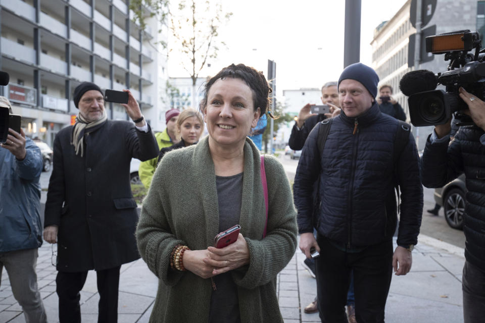 Polish author Olga Tokarczuk smiles as she arrives for a press conference in Bielefeld, Germany, Thursday, Oct 10, 2019. Tokarczuk has been named recipient of the 2018 Nobel Prize in Literature, Thursday. Two Nobel Prizes in literature were announced Thursday after the 2018 literature award was postponed following sex abuse allegations that rocked the Swedish Academy at that time. (Friso Gentsch/dpa via AP)