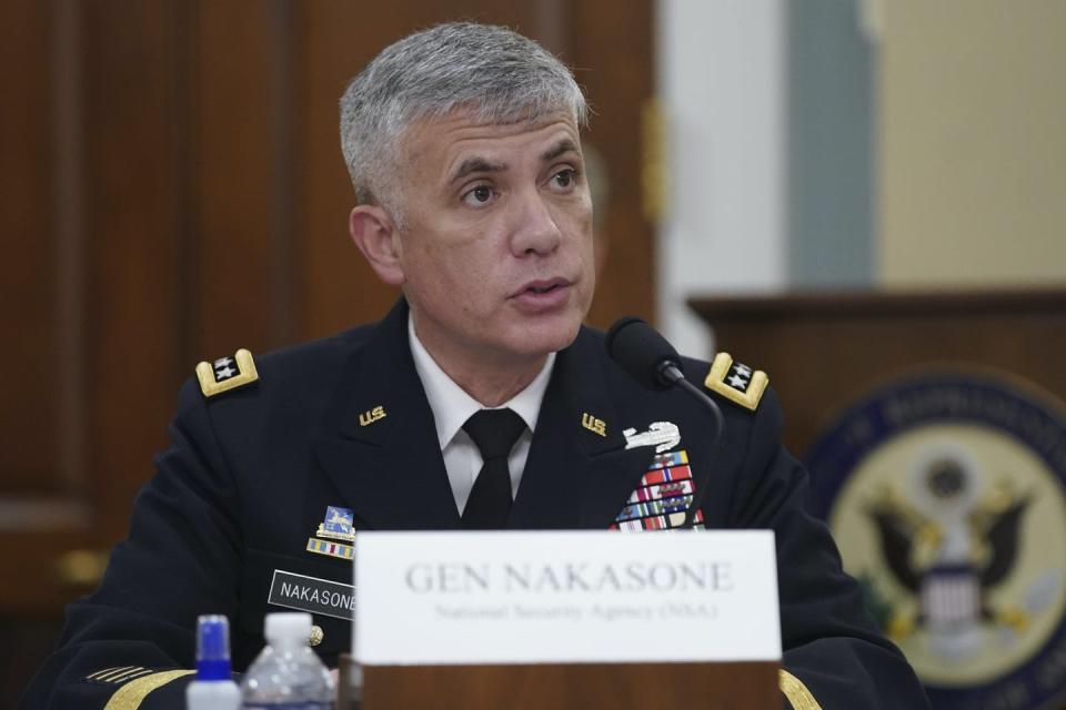 a man with salt-and-pepper hair wearing a dark blue military uniform