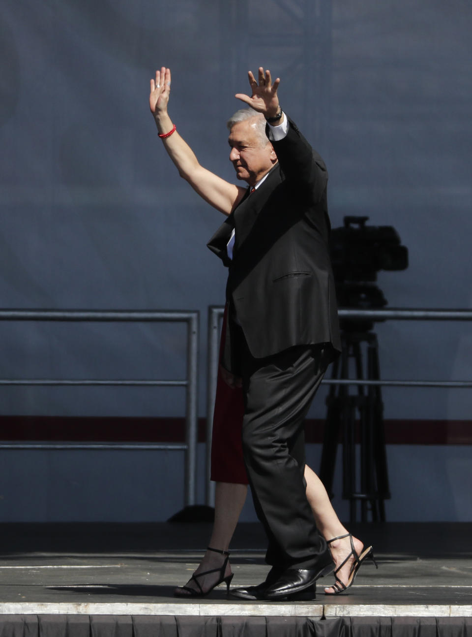 Mexico's President Andres Manuel Lopez Obrador arrives with his wife Beatriz Gutierrez Muller for a rally to commemorate his one year anniversary in office, at the capital’s main plaza, the Zocalo, in Mexico City, Sunday, December 1, 2019. Thousands of Mexicans have packed into the capital’s central square to celebrate Lopez Obrador’s first year in office, while thousands more marched down the city’s main avenue to protest violence and other ills in the country. (AP Photo/Marco Ugarte)