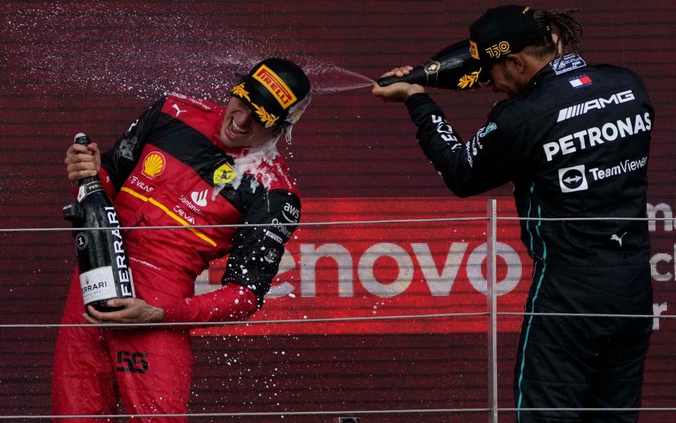 Lewis Hamilton (right) celebrates his podium finish - AP