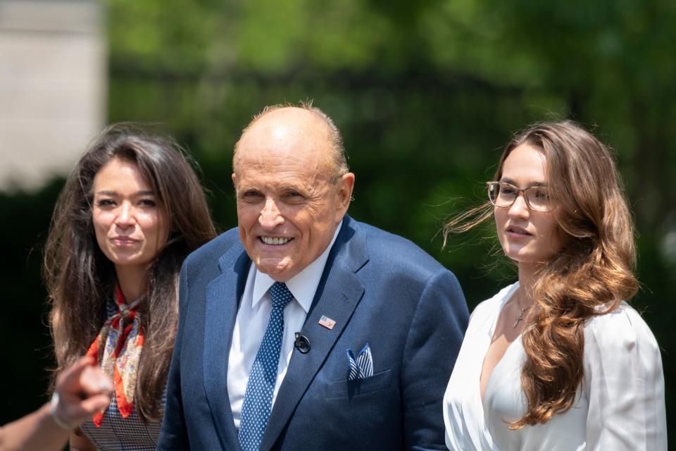 Rudy Giuliani, President Donald Trump's personal attorney, walks with his aide Christianne Allen (right) and One America News Network's Chanel Rion on July 1 after speaking at the White House. (Photo: JIM WATSON via Getty Images)