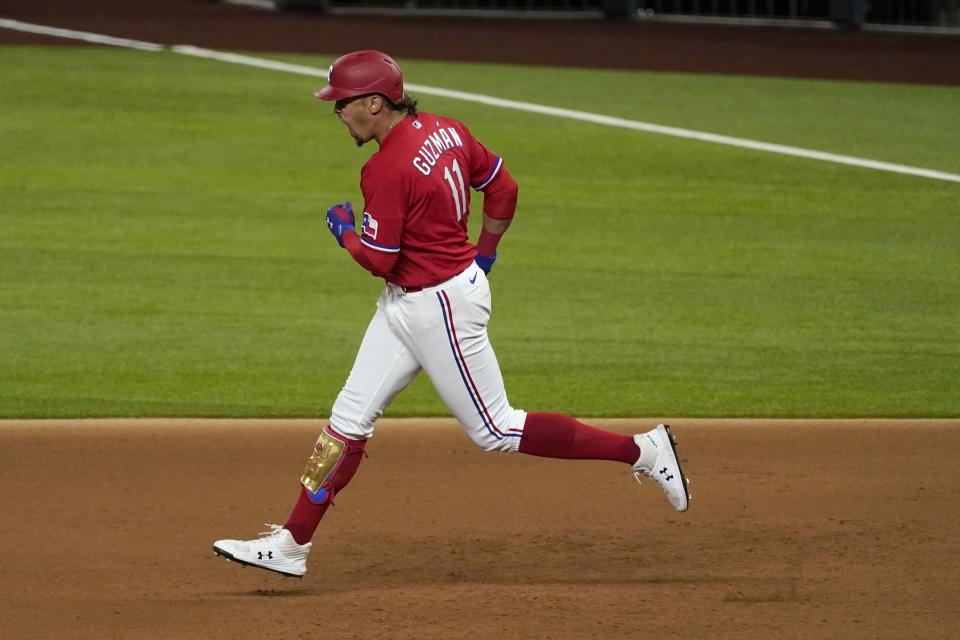 Texas Rangers' Ronald Guzman celebrates after hitting a solo home run on a pitch from Houston Astros' Ryan Pressly in the ninth inning of a baseball game in Arlington, Texas, Friday, Sept. 25, 2020. (AP Photo/Tony Gutierrez)