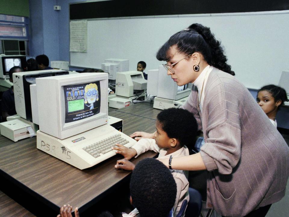 Students learning to use a computer in 1989