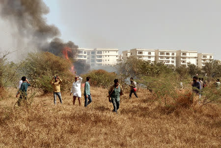 People gather near the site of a crashed Indian Air Force's Mirage 2000 trainer aircraft in the southern city of Bengaluru, India, February 1, 2019. REUTERS/Ismail Shakil