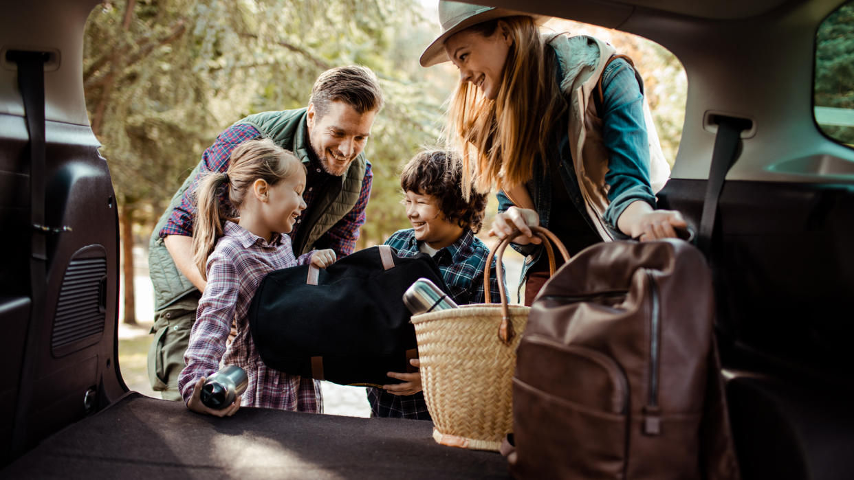 Close up of a young family packing up for a road trip.