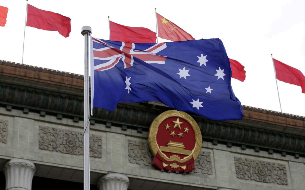 An Australian flag flutters in front of the Great Hall of the People in Beijing - Jason Lee/Reuters
