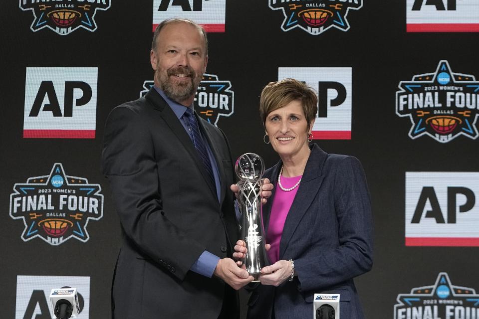 Indiana head coach Teri Moren poses with Associated Press Sports Products Director Barry Bedlan at a press conference after she was introduced as the AP Coach of the Year Thursday, March 30, 2023, in Dallas. (AP Photo/Darron Cummings)