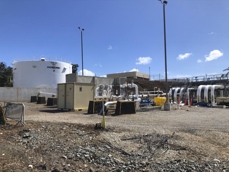 FILE - An above-ground fuel storage tanks stands at Joint Base Pearl Harbor-Hickam on Monday, Oct. 24, 2022. Three active-duty military members are taking the first step toward suing the U.S. government over jet fuel that contaminated drinking water in Hawaii. Their attorneys say the pre-litigation claim forms will allow them to later file a federal lawsuit in Honolulu. In 2021, jet fuel spilled from a drain line at a storage facility that flowed into a drinking water well and into the Navy's water system. (AP Photo/Audrey McAvoy, File)