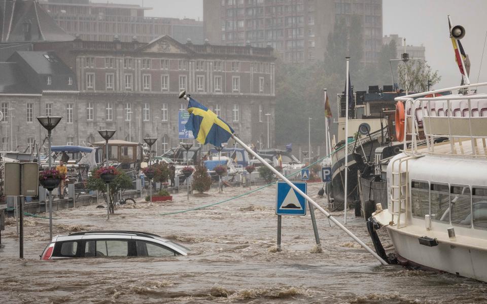 A car floats in the Meuse River in Liege (AP)