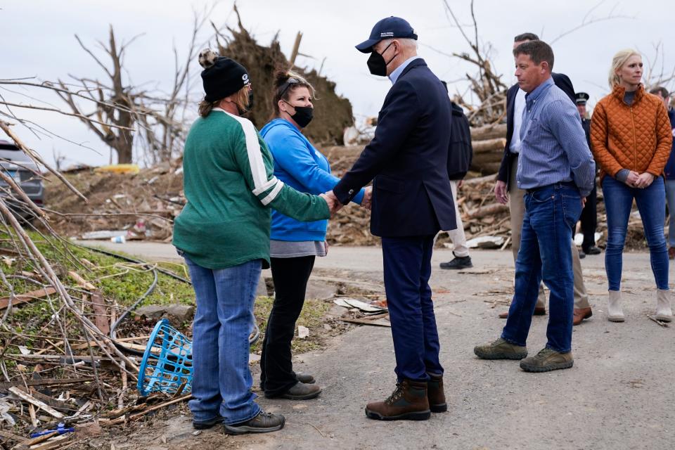 President Joe Biden speaks to people as he surveys storm damage from tornadoes and extreme weather in Dawson Springs, Kentucky, on Wednesday.