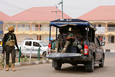 A police vehicle drives out of the INEC office in Yola, in Adamawa State, ahead of the country's presidential election, in Yola, Nigeria February 15, 2019. REUTERS/Nyancho NwaNri