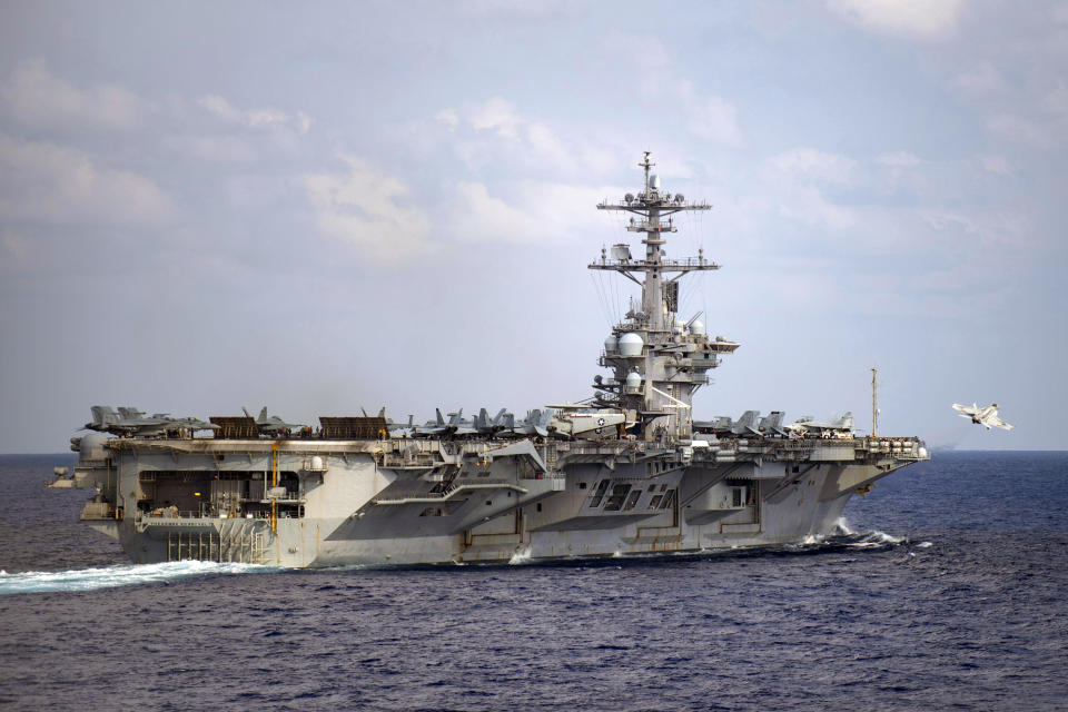 In this March 18, 2020, photo provided by the U.S. Navy, an F/A-18F Super Hornet launches from the flight deck of the aircraft carrier USS Theodore Roosevelt (CVN 71) in the western North Pacific Ocean. The Navy’s top admiral will soon decide the fate of the ship captain who was fired after pleading for his superiors to move faster to safeguard his coronavirus-infected crew on the USS Theodore Roosevelt. (Mass Communication Specialist 3rd Class Nicholas V. Huynh/U.S. Navy via AP))