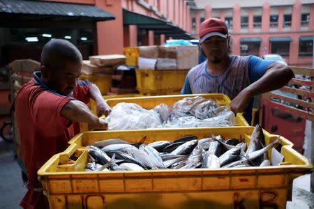 People move crates of fish at a market in Kota Bharu, Kelantan, Malaysia April 12, 2018. Picture taken April 12, 2018. REUTERS/Stringer