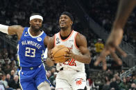 Miami Heat's Jimmy Butler (22) shoots past Milwaukee Bucks' Wesley Matthews (23) after being fouled during the first half of an NBA basketball game Saturday, Feb. 4, 2023, in Milwaukee. (AP Photo/Aaron Gash)