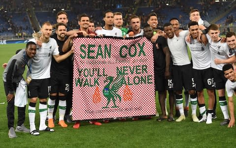 Liverpool players pay tribute to fan Sean Cox who remains in a coma - Credit: AFP