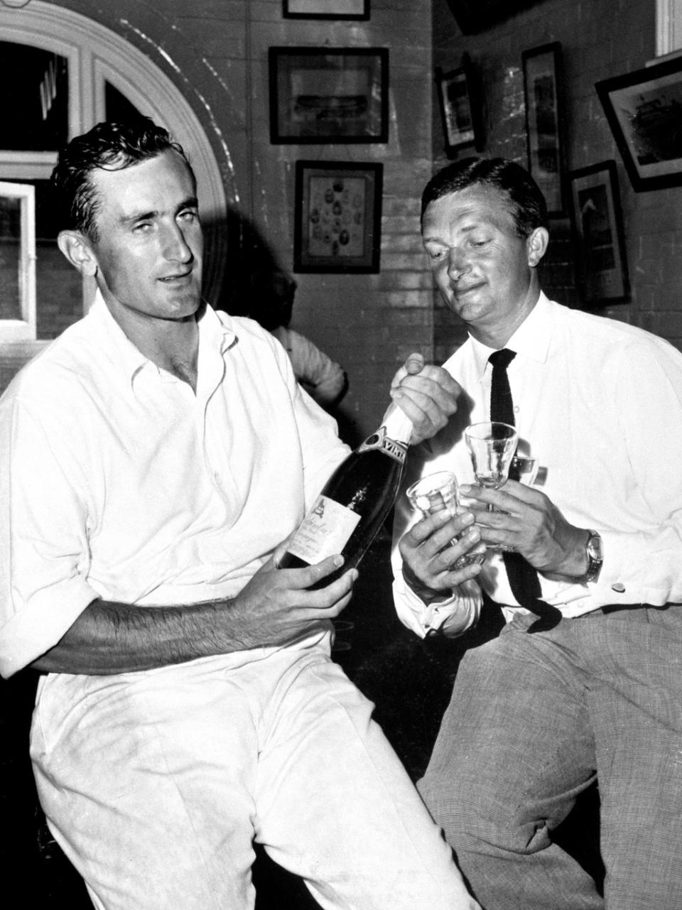 Ted Dexter, left, shares a drink with Australia captain Richie Benaud after an Ashes Test in 1963 (PA) (PA Archive)