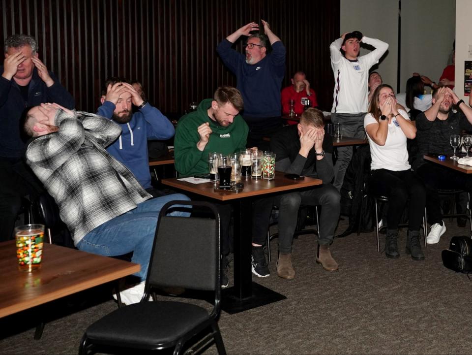 Fans covered their faces after Harry Kane missed a penalty (PA)
