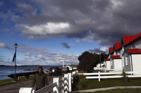 A man walks on Ross road in Stanley, March 11, 2013. REUTERS/Marcos Brindicci/File Photo