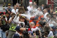 Mercedes Formula One driver Nico Rosberg (C) of Germany sprays champagne as he celebrates winning the Monaco F1 Grand Prix in Monaco May 25, 2014. Rosberg won the showcase Monaco Grand Prix for the second year in a row on Sunday to snatch back the Formula One world championship lead from Mercedes team mate Lewis Hamilton. REUTERS/Stefano Rellandini (MONACO - Tags: SPORT MOTORSPORT F1)