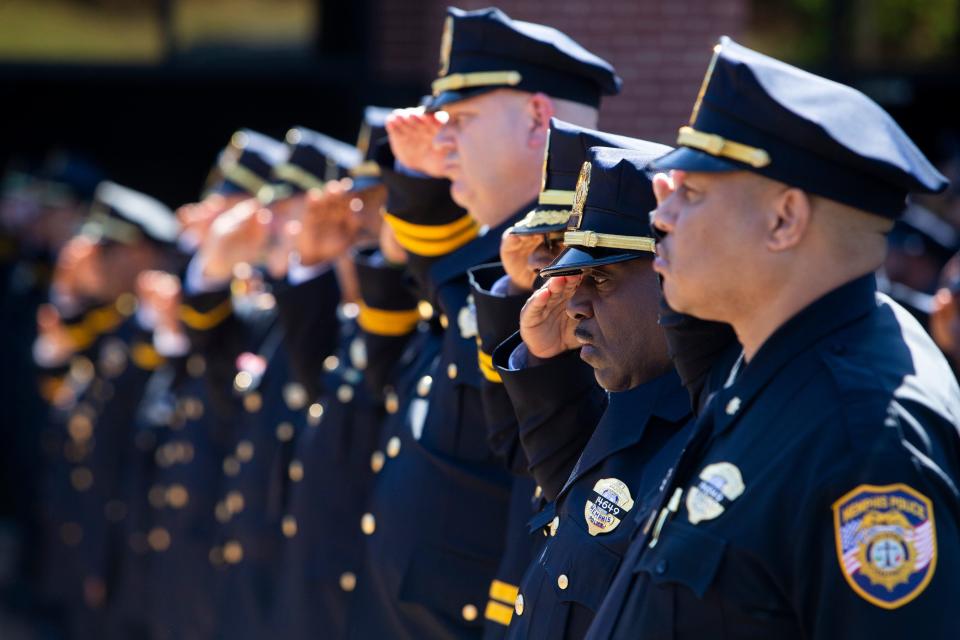 Memphis Police Department officers salute the casket of Joseph McKinney, a Memphis Police Department officer who was killed during a shootout on April 12, as it is carried out of Hope Church by pallbearers and brought to a hearse after McKinney’s funeral in Cordova, Tenn., on Monday, April 22, 2024.