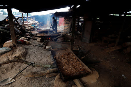 Gold ore is roasted on a fire at the unlicensed mining site of Nsuaem Top in Ghana, November 24, 2018. REUTERS/Zohra Bensemra