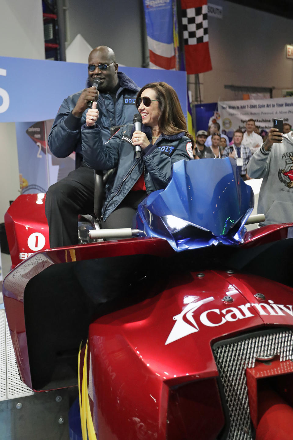 Christine Buffy, front right, president of Carnival Cruise Line's introduces the first roller coaster that will be on a cruise ship with former NBA star and Carnival's chief fun officer, Shaquille O'Neal during the International Association of Amusement Parks and Attractions convention Tuesday, Nov. 19, 2019, in Orlando, Fla. (AP Photo/John Raoux)