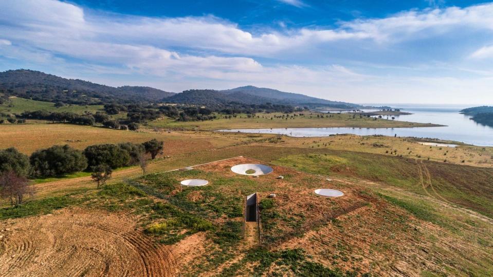 A zoomed-out aerial view reveals just how hidden Casa na Terra is thanks to its grassy roof. 