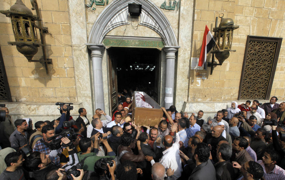 Egyptians carry the coffin of Egypt’s best known satirical poet, Ahmed Fouad Negm following funeral prayers at al-Hussein mosque in Cairo, Egypt, Tuesday, Dec. 3, 2013. Known as the "poet of the people," Negm's use of colloquial Egyptian Arabic endeared him to his countrymen who saw in his verse an unvarnished reflection of how they felt about milestones in their nation's history like the humiliating defeat at the hands of Israel in 1967, the 1979 peace treaty with Israel and the authoritarian rule of Hosni Mubarak. (AP Photo/Amr Nabil)