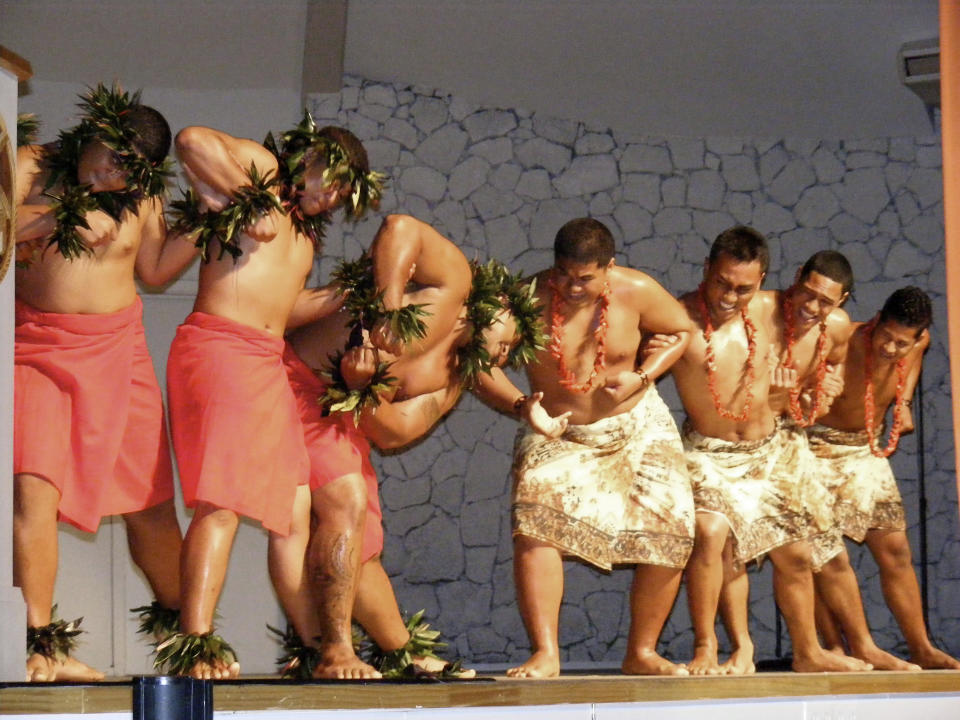 FILE - In this July 7, 2009 file photo. dancers representing Hawaii and the Samoas join to form a link at a ceremony celebrating the launch of a new fiber optic cable in Pago Pago, American Samoa. Many residents of American Samoa are concerned that a federal judge's recent ruling in Utah, saying those born in the U.S. territory should be recognized as U.S. citizens, could threaten "fa'a Samoa," the Samoan way of life, which includes cultural traditions like prayer curfews, communal living and a belief that the islands' lands should stay in Samoan hands. (AP Photo/Fili Sagapolutele, File)