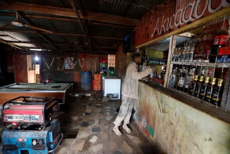 An informal miner orders a drink during his lunch break at Stephe Ble's bar at the mining site of Nsuaem-Top