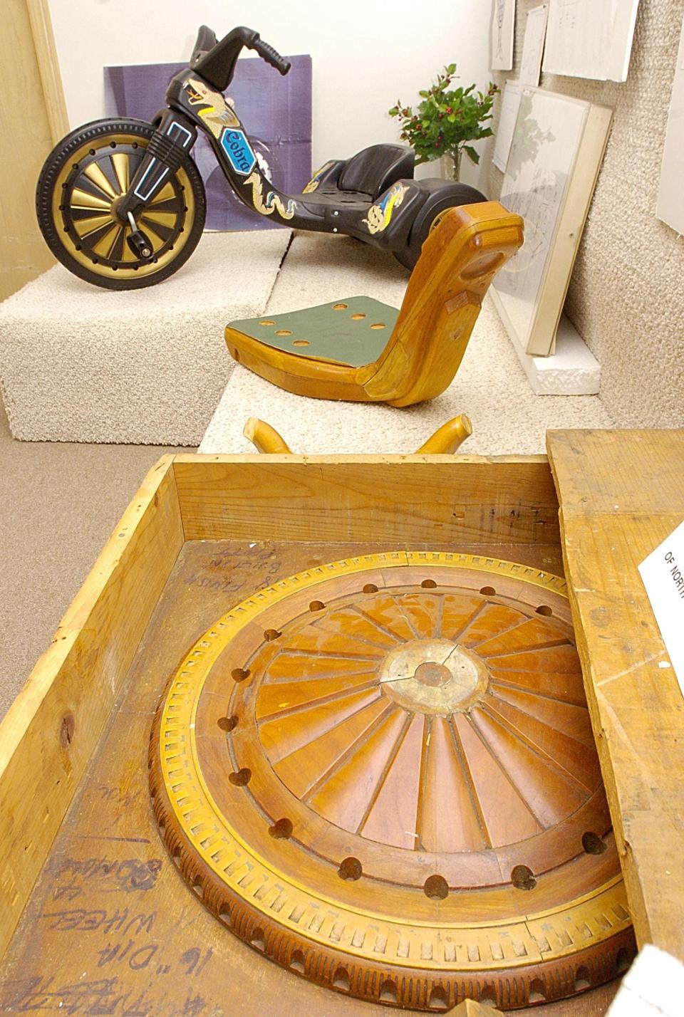 Original patterns of the body and front wheel of the plastic Big Wheel tricycle are shown, Dec. 11, 2004, at the Marx Toy Museum, located at 50 E. Bloomfield Parkway in Summit Township. The Big Wheel Cobra is in the background. It was the last version of the Big Wheel made by Marx Toy Company, which was founded in Erie in the mid-1930s by Louis Marx and closed in September 1975. In its 40 years of existence, millions of toys were assembled at Marx's Erie plant on West 12th Street. Among the toys that rolled off the assembly line were the Rock 'em Sock 'em Robots, Big Wheel and Penny the Poodle. Many of the toys were designed and engineered in Erie as well. At the Marx plant in Girard, workers produced the company's electric train sets. The museum in Summit Township closed in April 2008. Museum items were auctioned off in June of that year and the building was later demolished.