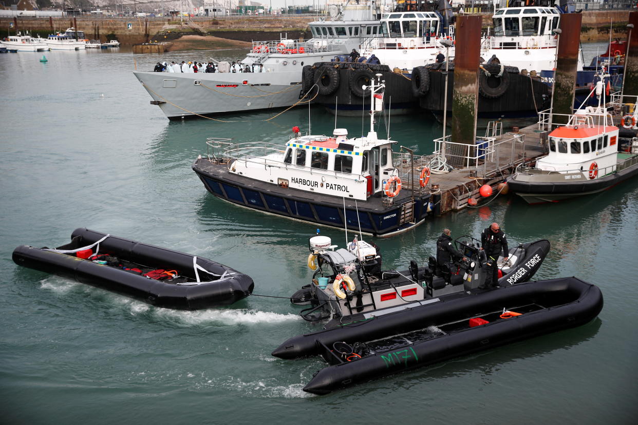 Members of Britain's Border Force tow into the Port of Dover an inflatable boat used by migrants who were rescued while crossing the English Channel, in Dover, Britain, April 14, 2022. REUTERS/Peter Nicholls