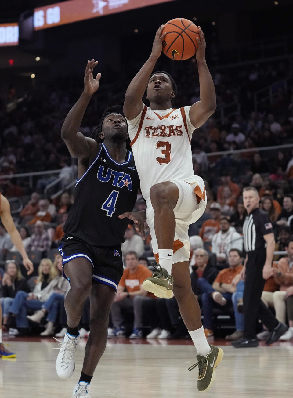 Texas guard Max Abmas (3) drives to the basket against Texas-Arlington guard Akili Vining (4) during the second half of an NCAA college basketball game in Austin, Texas, Monday, Jan. 1, 2024. (AP Photo/Eric Gay)