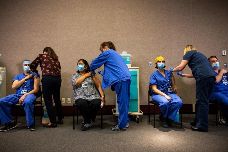<div class="inline-image__caption"><p>Healthcare workers get the Pfizer-BioNTech COVID-19 vaccination at the Legacy Emanuel Medical Center on December 16, 2020 in Portland, Oregon. </p></div> <div class="inline-image__credit">Paula Bronstein/Getty Images</div>