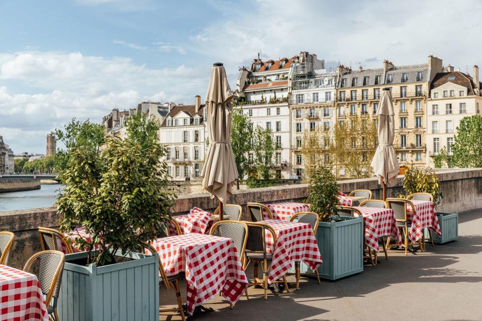 cafe on the bank of seine river on a sunny day, paris, france