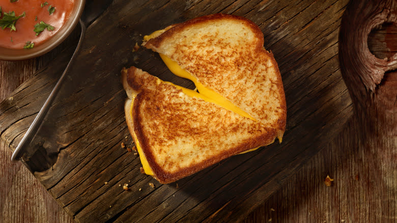 Grilled cheese sandwich on wooden cutting board
