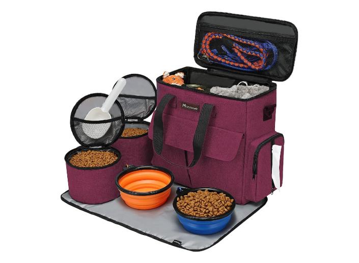 A travel bag for pets with dog food and lots of other amenities filling its containers.