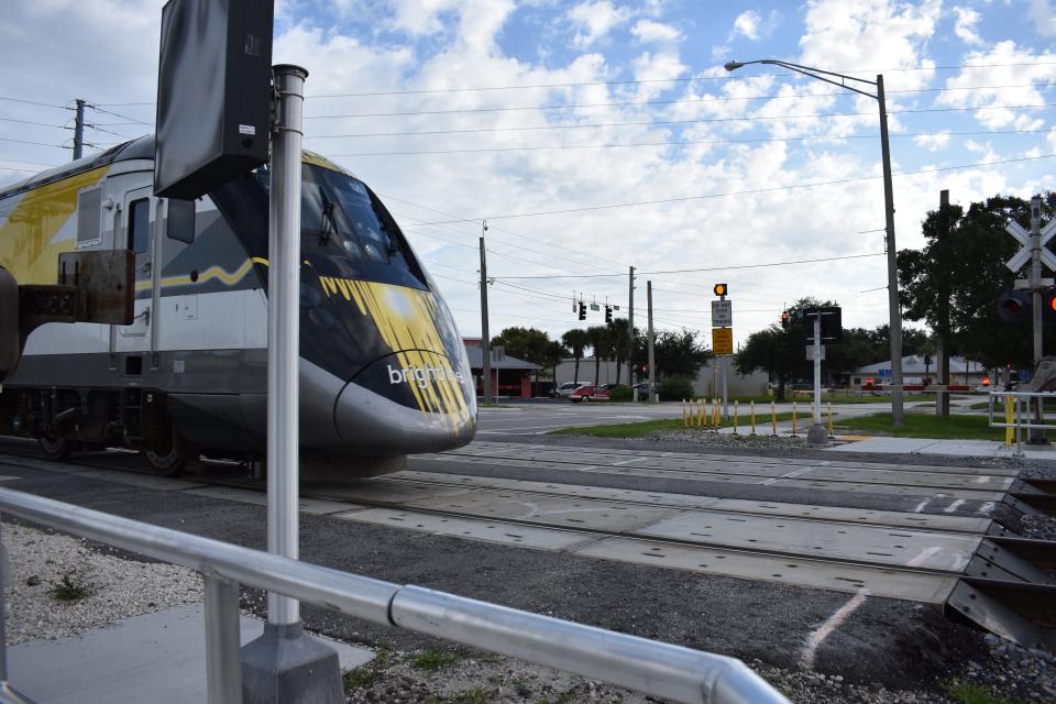 A southbound Brightline train carrying passengers from Orlando to Miami crosses East State Road 60, where 19th Place becomes 20th Street, in Vero Beach, Fla., on Monday, Oct. 9, 2023, the day the high-speed rail carrier increased its Miami-to-Orlando service from 16 to 30 trains daily.