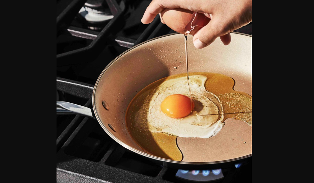 Egg frying in copper Material Kitchen coated pan.