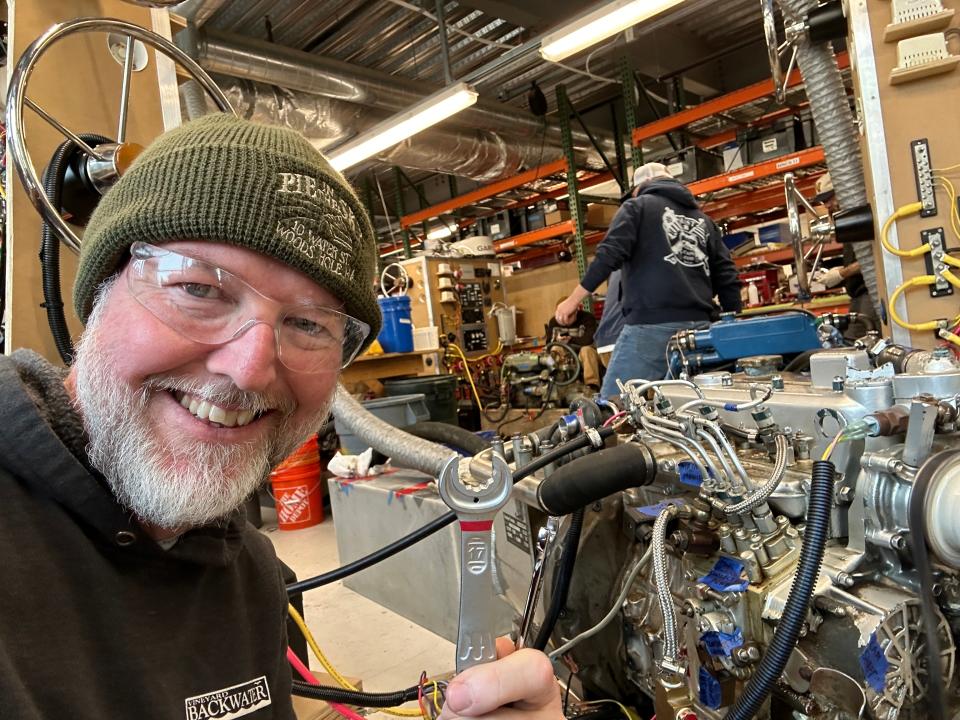 Nick Willis works on a marine diesel engine.