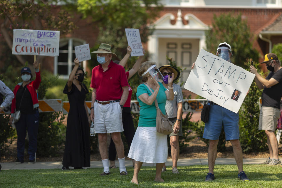 SAN MARINO, CA - AUGUST 22: Protesters rally outside the home of USPS Board of Governors John M. Barger to decry recent U.S. Postal Service cuts by Postmaster General Louis DeJoy that could effect presidential election mail-in ballots on August 22, 2020 in San Marino, California. The protesters say that John Barger, a GOP donor appointed to the Postal Service Board of Governors by President Trump, is responsible for appointing Louis DeJoy to be the Postmaster General. The demonstration is one of many post office rallies spread across the region to reduce the crowd size at any single location because of COVID-19 safety concerns.  (Photo by David McNew/Getty Images)