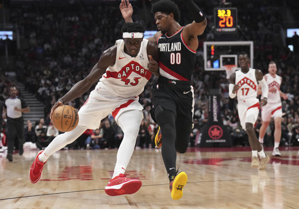 Toronto Raptors forward Pascal Siakam (43) moves the ball upcourt as Portland Trail Blazers guard Scoot Henderson (00) defends during first-half NBA basketball game action in Toronto, Monday, Oct. 30, 2023. (Nathan Denette/The Canadian Press via AP)