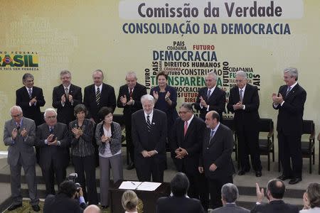 Brazil's President Dilma Rousseff (back, 4th R) and former President Luiz Inacio Lula da Silva (back, 4th L) applaud during the inauguration of the National Truth Commission in the Palacio do Planalto in Brasilia in this May 16, 2012 file photo. REUTERS/Ueslei Marcelino