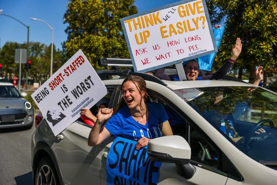 People participate in a rally as they drive by nurses on strike outside of Lucile Packard Children's Hospital on Monday, April 25, 2022, in Palo Alto, Calif.